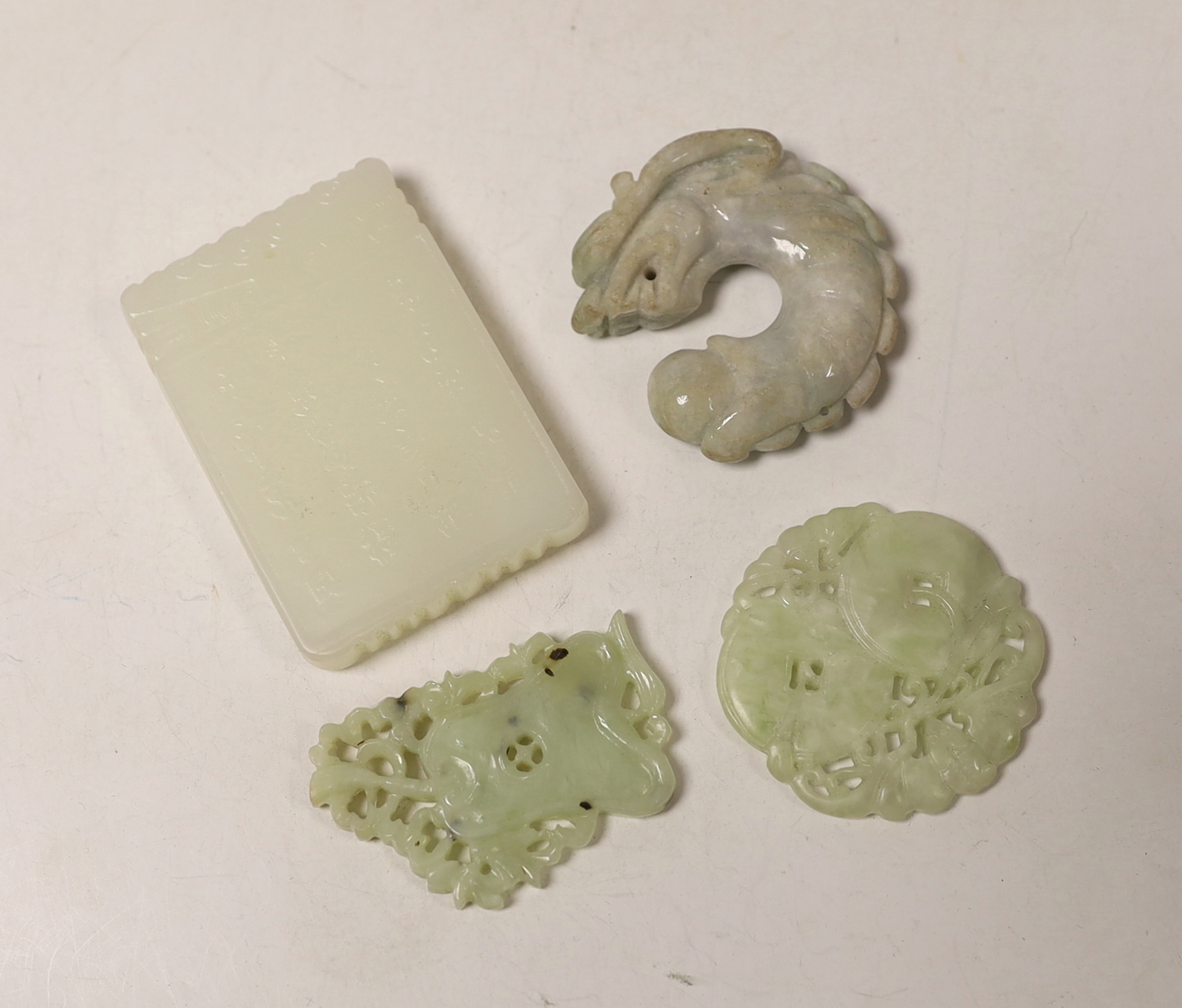 A Chinese white jade pendant plaque and three jadeite pendants, largest 7cm